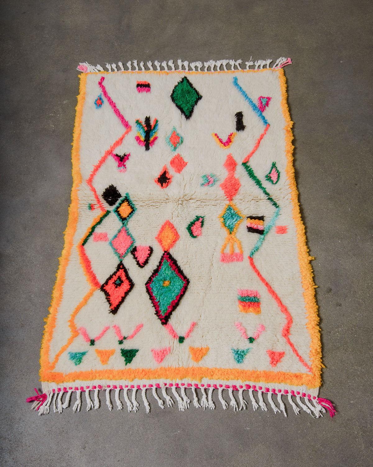 Colorful geometric patterned rug on a gray floor